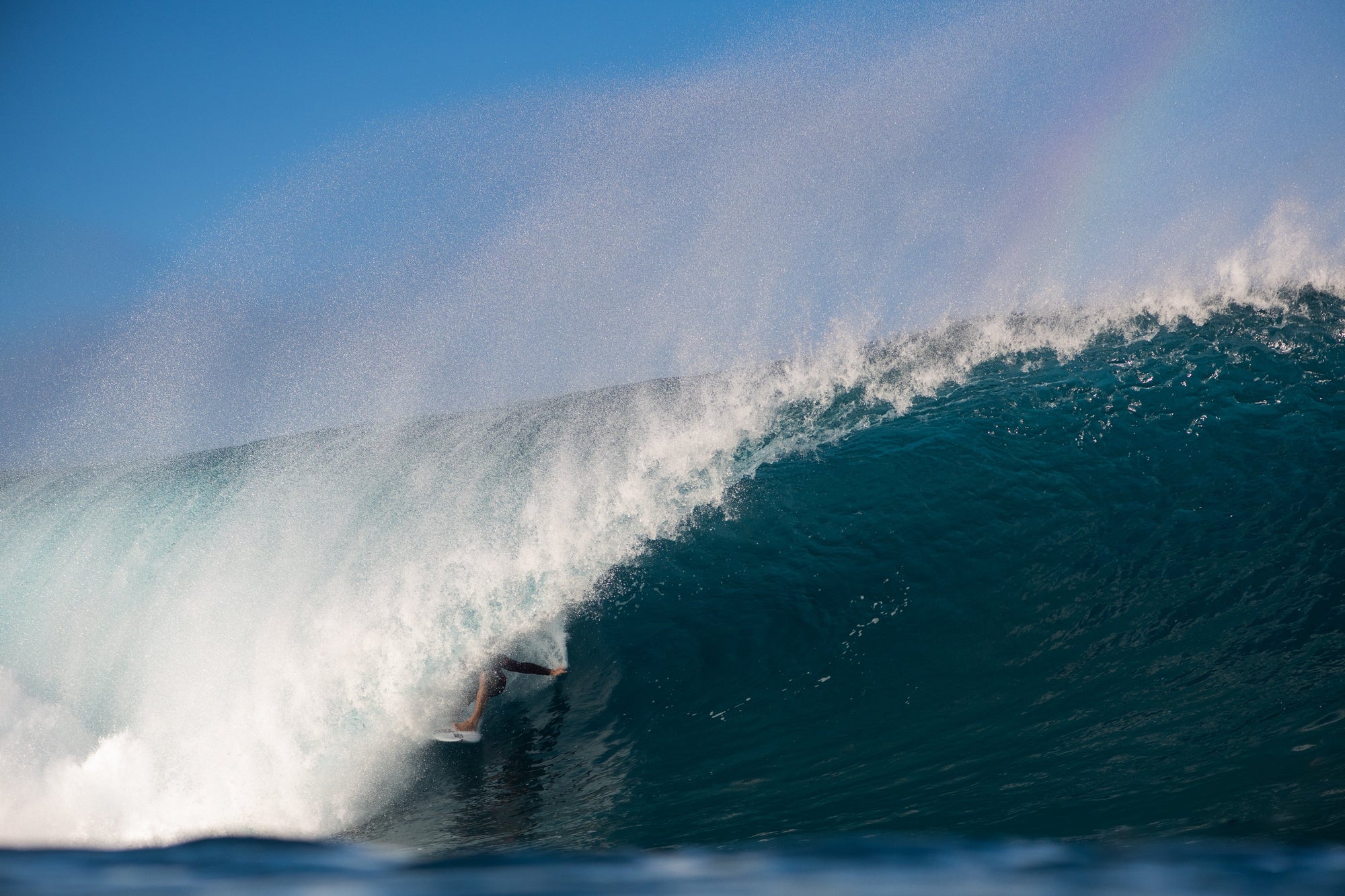 Surfer goes through a huge wave